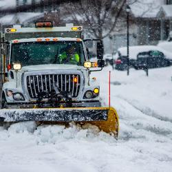 Snowplow truck clearing residential roads